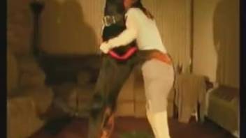 Dark-haired woman in a skirt is fucked by a savage dog