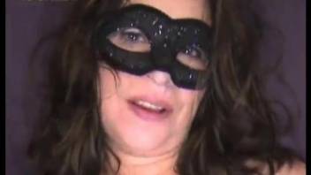 Brunette MILF in mask presents cunt to her pets
