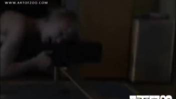 Blond woman pleasures herself in front of the dog, enticing it as she goes