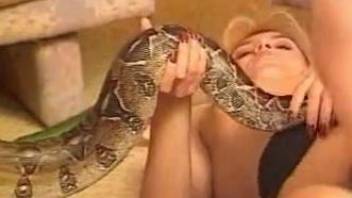 Blonde shoves an actual fucking snake up her pussy