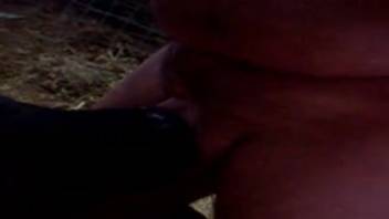 Guy screwing his beast in the shadows, within a stable