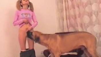 Naive-appearing schoolgirl giving oral to a dog's penis in this spot