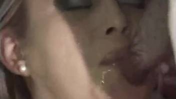 Blond woman displaying her oral sex abilities in an adult video involving a dog