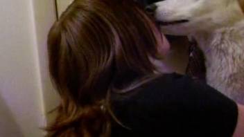 Husky making out with its emo-looking owner