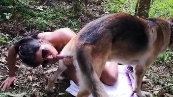 Nude woman fucks with the dog in full outdoor zoo glory