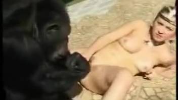 Blond woman with odd hairstyle performs oral on a canine